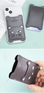 Detail of grey cat-shaped leather phone card holder showing interior texture and usage