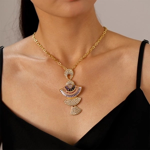 Close-up of luxury gold fan-shaped necklace with colorful zircon inlay on model