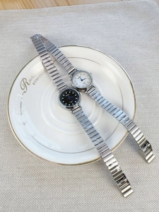 Detail of silver quartz watches with diamond markers in black and white dial versions