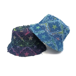 Distressed denim bucket hat with star pattern and frayed edges in blue and purple