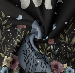 Macro detail of bohemian black tapestry fabric showing moon and floral prints