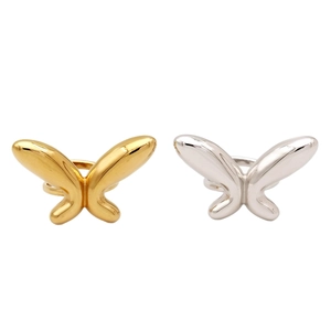 Polished stainless steel butterfly ring set in gold and silver finish on white background