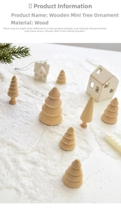 Miniature wooden Christmas tree set on white artificial snow for festive table decoration