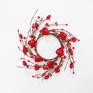 Detail view of heart-shaped wreath with red berries on brown twig base for Valentines Day