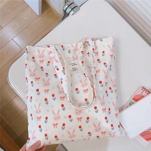 Detail of cute rabbit and tulip print on white cotton canvas tote with interior woven label