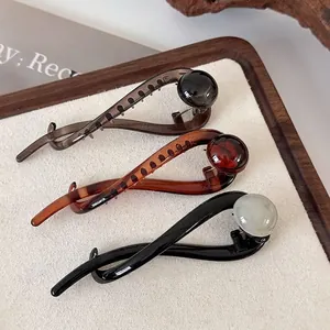 Vintage-style curve hair claw set in amber, smoky grey, and black marble bead designs