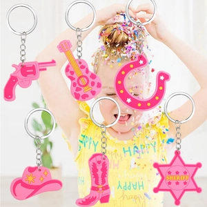 Set of 6 pink PVC western cowboy keychains with guitar, hat, boots, and sheriff star symbols
