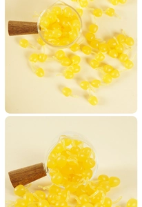 Macro shot of realistic yellow PVC mini cherry charms for handmade DIY crafts decoration