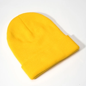 Detailed close-up of lemon yellow ribbed knit beanie with thick texture and wide cuffed brim