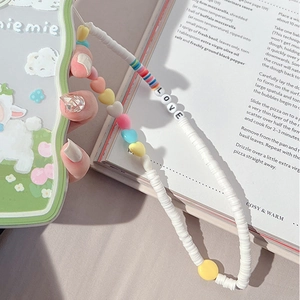 Detail of beaded phone strap with colorful heart charms and LOVE letter beads on white cord