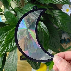 Handheld crescent moon suncatcher with rainbow prism effect and black frame decoration