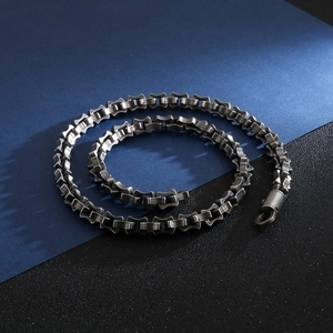 Detail of silver industrial gear chain necklace with high metallic luster and secure clasp