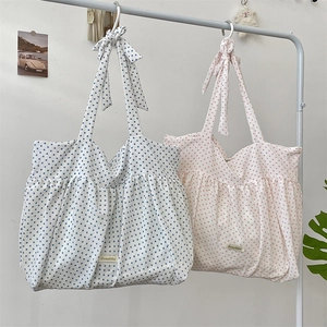 Detailed shot of pleated polka dot canvas tote bags with cute bow handle decorations