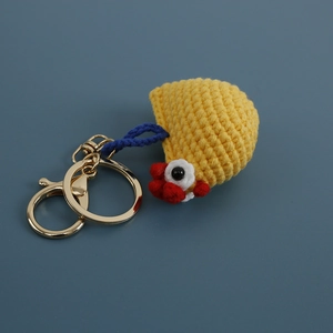 Handmade crochet yellow chicken head keychain with red crest and golden metal clasp