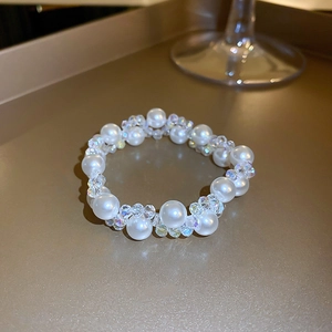 Detail of French vintage necklace with artificial pearls and faceted crystal beads