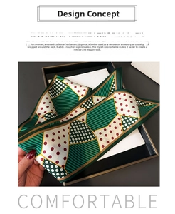 Close-up of geometric polka dot silk scarf in emerald green and burgundy on gift box