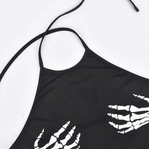 Detail of black halter crop top with white bone skeleton hand print on the chest