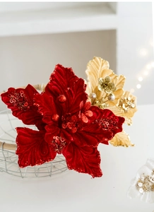 Detail of elegant red velvet and champagne gold sequined Christmas flowers in a basket
