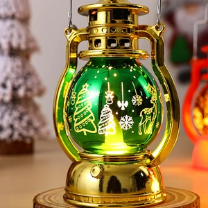 Detail of vintage gold Christmas lantern with green glass and tree reindeer patterns