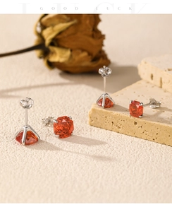 Detailed view of red rose-cut gemstones set in S925 sterling silver ear studs