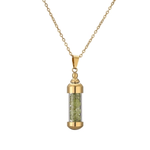 Detail of gold capsule pendant filled with green natural stones on fine O-chain necklace