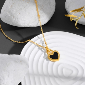 Golden titanium steel heart necklace with double-sided black shell pendant on white stone