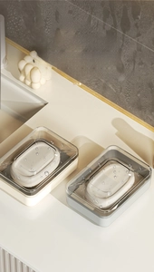 Close-up of cream and grey soap boxes with waterproof lids and drainage trays