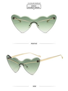 Detail view of heart shaped rimless sunglasses with gold frame and double green lenses
