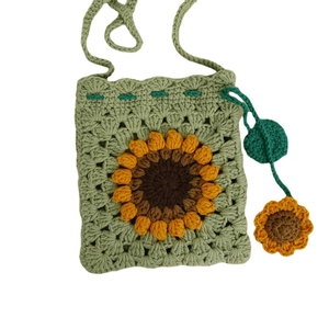 Handmade crochet green crossbody bag featuring a 3D sunflower pattern for kids