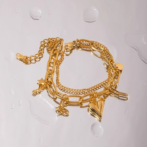 18K gold plated stainless steel layered bracelet with heart and star charms on water drop surface