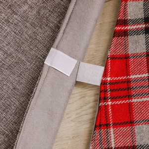 Christmas tree skirt with red grey plaid pattern and velcro closure on wooden floor