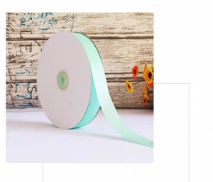 Detail of 2cm mint green satin ribbon roll for gift wrapping and cake decoration