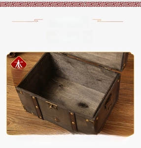 Detail of vintage dark wood storage box with metal rivets and light wood interior