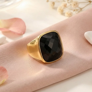 Detailed view of square black crystal stone on thick gold stainless steel ring
