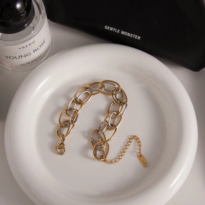 Two-tone stainless steel chain bracelet with interlocking oval links in gold and silver
