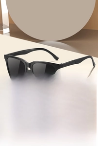 Detailed close-up of classic black square fashion sunglasses with dark polarized lenses