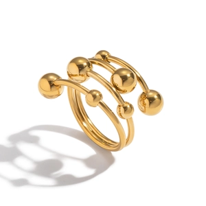 Detailed macro view of layered golden spiral ring with polished bead ends and mirror finish