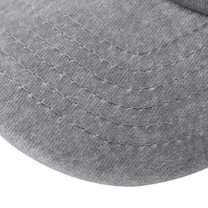 Detailed macro view of the grey baseball cap brim with reinforced curved stitching