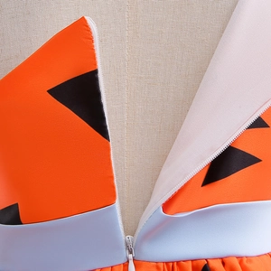 Detail of the hidden back zipper on a girls' orange and black pumpkin costume dress