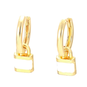 Close-up of golden hoop earrings with white enamel lock charms and smooth metal finish