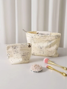Two-piece portable cream makeup bag set with black bow patterns and polka dots