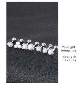 Close-up of six minimalist 925 silver pearl stud earrings with screw back design