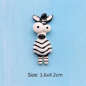 Detail view of a cute resin zebra DIY charm with dimensions 1.6x4.2cm on blue wood