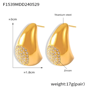 Détail de boucles d'oreilles goutte en acier titane avec zirconiums sur fond blanc