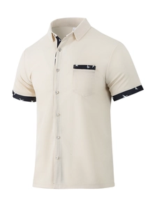 Close-up of beige waffle knit short sleeve shirt featuring geometric print trim on pocket