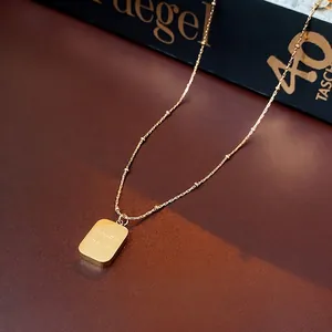 Titanium steel gold necklace featuring a square pendant engraved with CHARM on a bead chain
