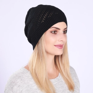 Close-up of lightweight black hollow-knit beanie showing breathable texture and ribbed hem