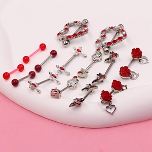 Macro shot of silver body piercing jewelry set with red zircon hearts and roses