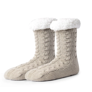 Cozy beige cable knit slipper socks with thick white fleece lining for winter warmth
