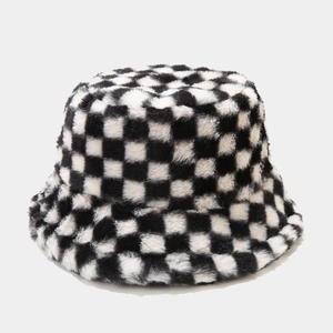 Close-up of the plush black and white checkerboard faux fur texture on the bucket hat